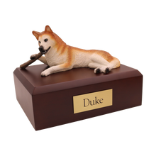 Red and White Husky, Chewing Stick Figurine Pet Cremation Urn - Funeral.com, Inc.